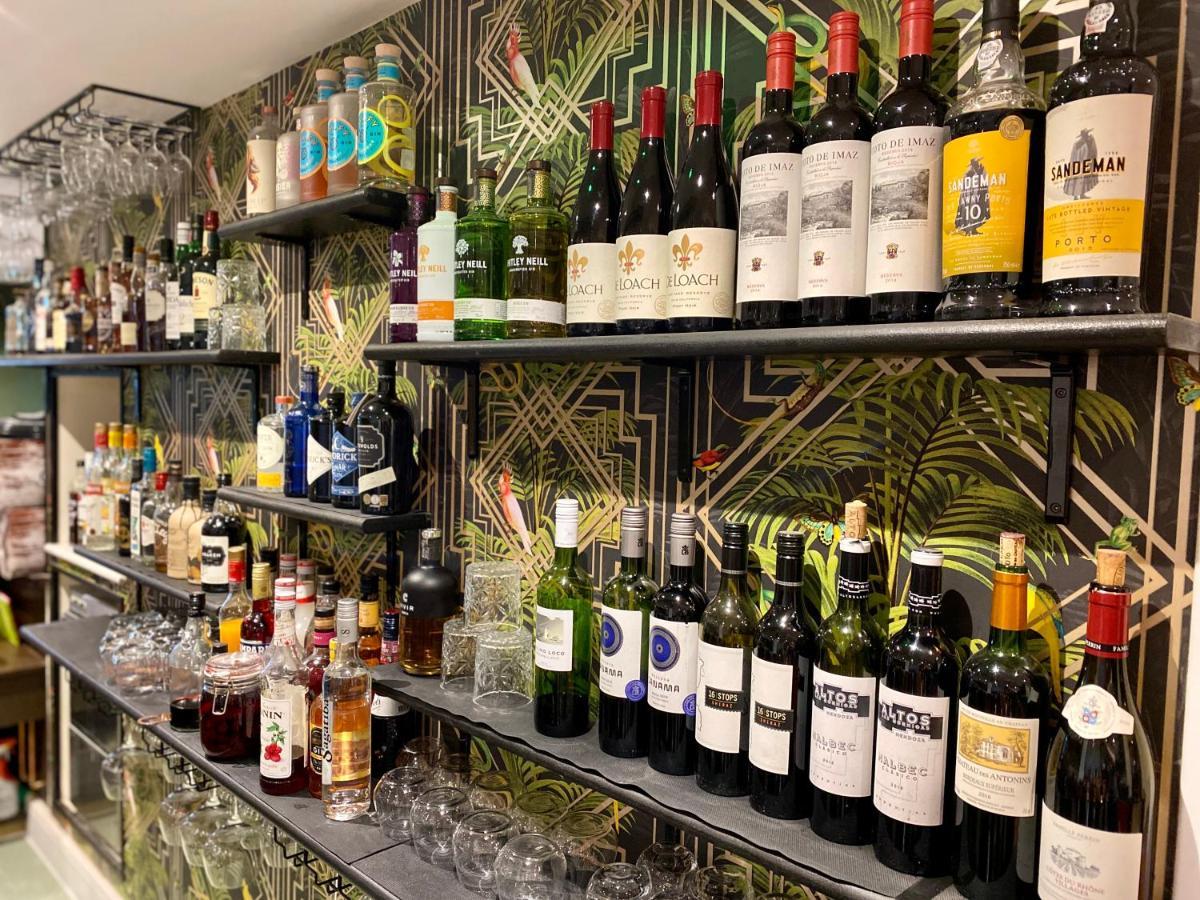 The Lion At West Pennard Hotel Exterior photo A selection of wine and spirits at the bar